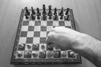 Low angle view of man playing on chess board