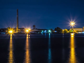 Scenic view of illuminated chao phraya river against sky at night