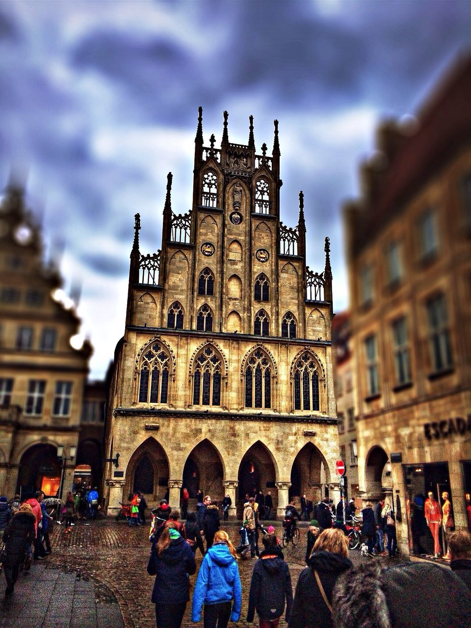 building exterior, architecture, built structure, large group of people, sky, men, person, lifestyles, cloud - sky, city, leisure activity, street, cobblestone, history, city life, old town, facade, building, walking