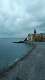 View of beach against cloudy sky