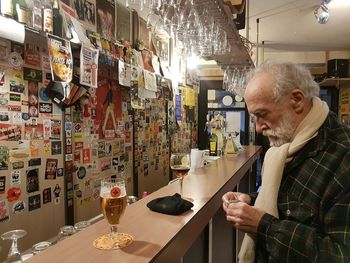 Man looking at illuminated shop