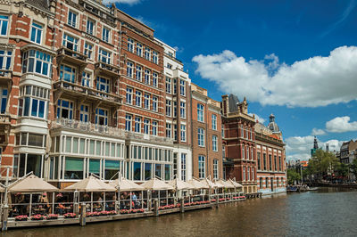 Canal with typical brick building and restaurant in amsterdam. the netherland capital full of canals