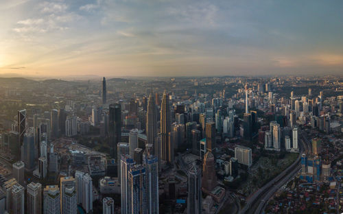 High angle view of city buildings against sky during sunset