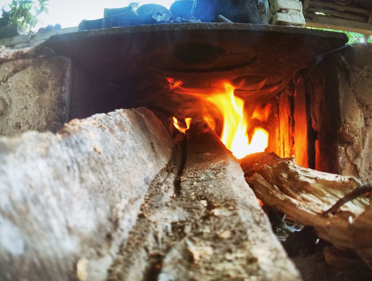 flame, burning, heat - temperature, built structure, fire - natural phenomenon, architecture, wood - material, firewood, building exterior, glowing, close-up, bonfire, brick, outdoors, orange color, day, fire, fire pit