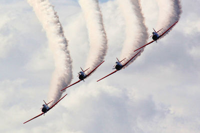 Low angle view of airshow against sky