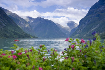 Scenic view of lake and mountains against sky