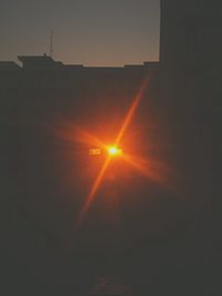 Silhouette building against sky during sunset