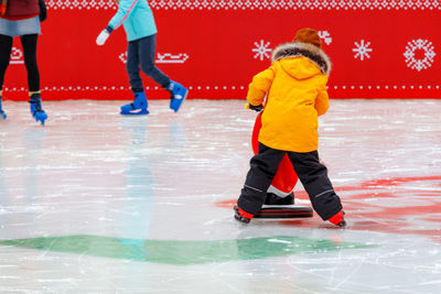 Full length of boy ice skating on ice