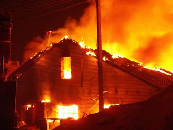 Illuminated building against sky at night