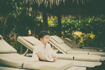 Portrait of boy sitting on table