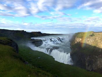 Scenic view of landscape against cloudy sky
