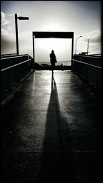 Silhouette people standing against sky