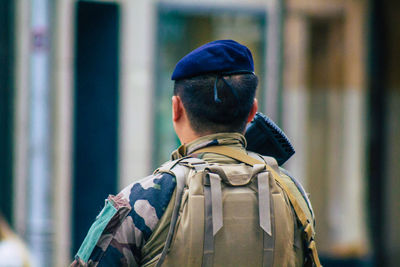 Rear view of man looking at camera