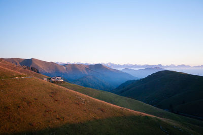 Scenic view of mountains against clear blue sky