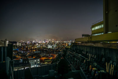 High angle view of illuminated buildings in city at night