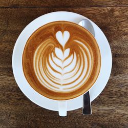 Directly above shot of cappuccino served on table