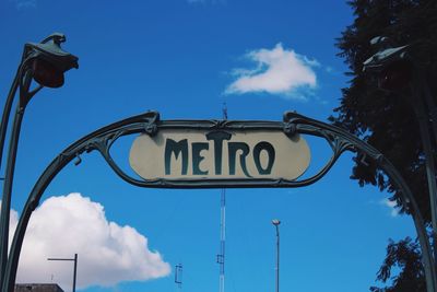 Low angle view of information sign against sky