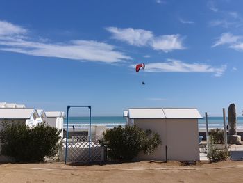 Basketball hoop by sea against sky