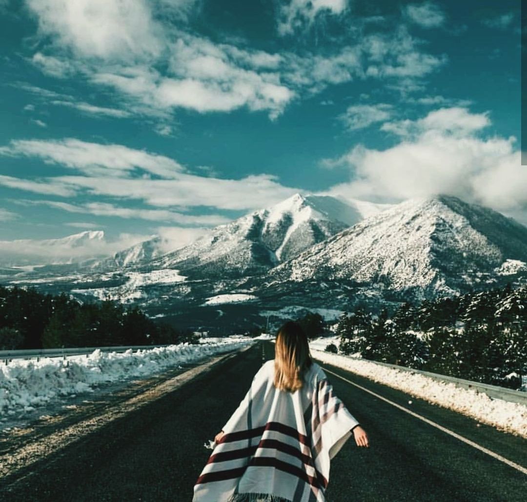 mountain, sky, cloud - sky, rear view, snow, one person, real people, beauty in nature, cold temperature, scenics - nature, transportation, nature, winter, day, women, lifestyles, snowcapped mountain, mountain range, leisure activity, outdoors, hairstyle, warm clothing