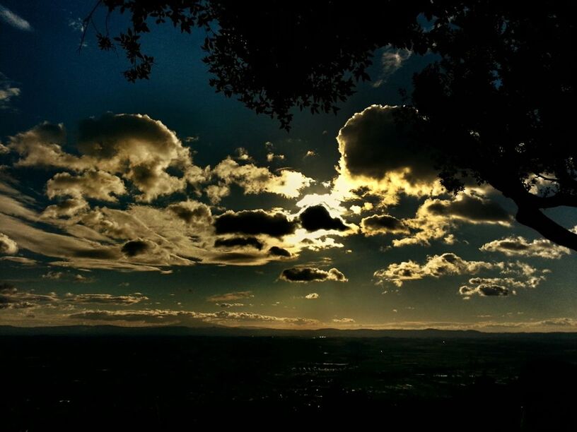 SILHOUETTE LANDSCAPE AGAINST CLOUDY SKY AT SUNSET