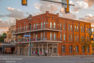 Facade of building against cloudy sky