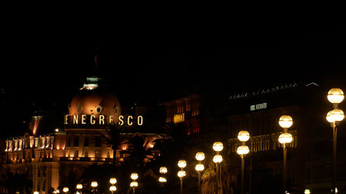 Illuminated city against sky at night