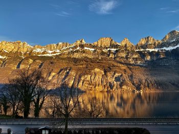 Scenic view of snowcapped mountains against blue sky