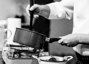 Midsection of man preparing food in kitchen