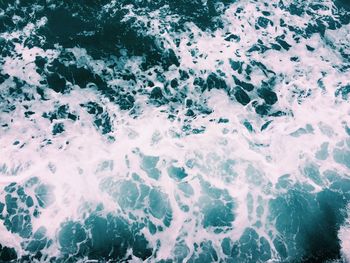 High angle view of waves splashing in sea