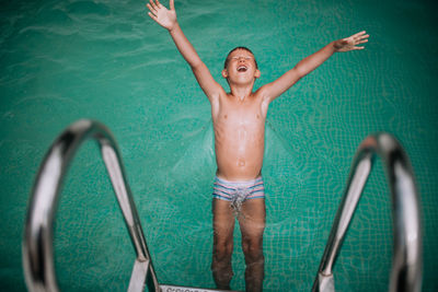 Full length of shirtless boy in swimming pool