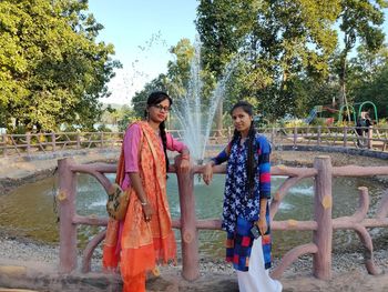 Women smiling young woman against trees and plants