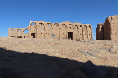 View of old ruins against clear blue sky