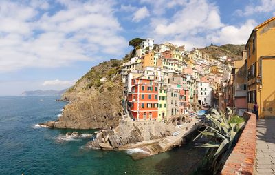 Panoramic view of sea and buildings against sky