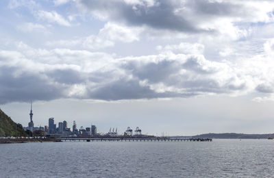 Panoramic view of sea and buildings against sky