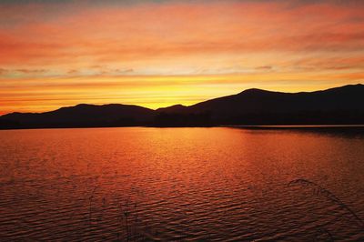 Scenic view of silhouette mountains against sky during sunset