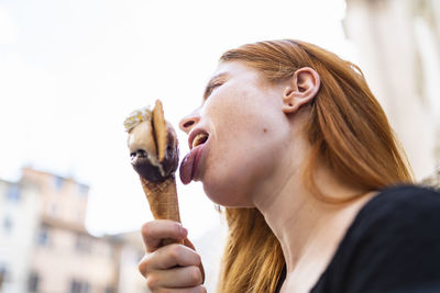 Young woman licking ice cream