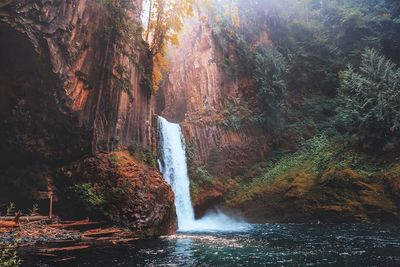 Scenic view of river flowing through rocks