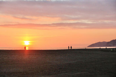 Scenic view of beach against sky during sunset