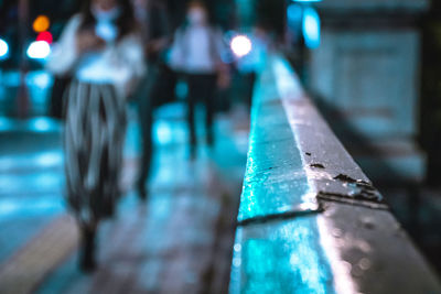 Close-up of illuminated light bulb on table in city