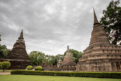 Old temple building against cloudy sky