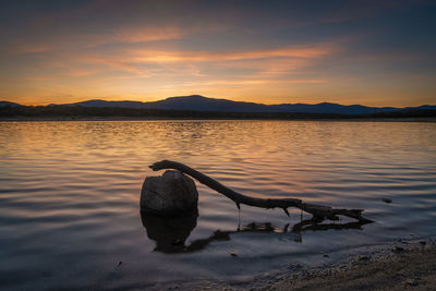 Scenic view of lake against sky during sunset