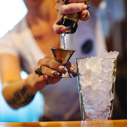 Midsection of man preparing food in glass