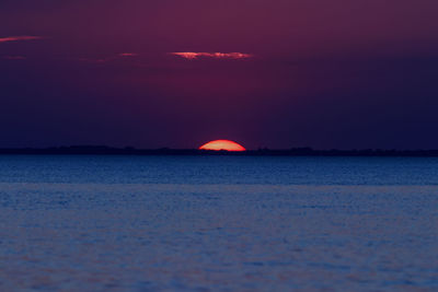 Scenic view of sea against romantic sky at sunset