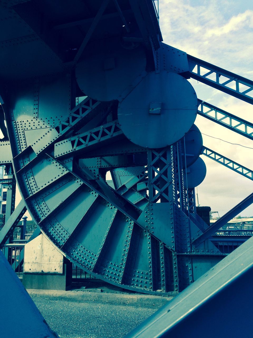 architecture, built structure, low angle view, metal, sky, building exterior, metallic, engineering, famous place, bridge - man made structure, industry, city, travel destinations, travel, connection, railing, capital cities, cloud - sky, factory, no people