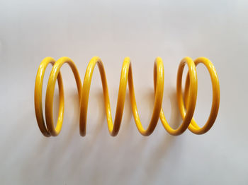 Close-up of yellow spiral over white background