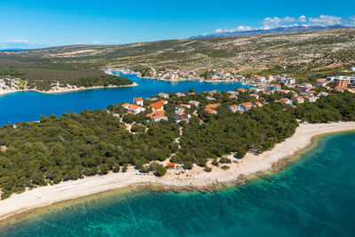 High angle view of townscape by sea against sky