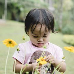 Close-up of boy blowing flowers
