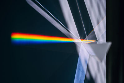 Close-up of illuminated lighting equipment against black background