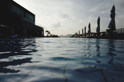 Swimming pool at resort against sky
