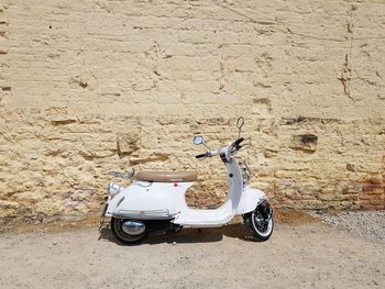 Motor scooter against wall